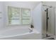 Bright bathroom featuring a large soaking tub, a glass door shower, and natural lighting at 4270 Parnell Rd, Marietta, GA 30062