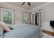 Comfortable bedroom with two windows, a ceiling fan, and view into the foyer at 4270 Parnell Rd, Marietta, GA 30062