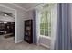 Inviting room featuring a large window with sheer curtains, carpeted floor, and adjacent study area at 4270 Parnell Rd, Marietta, GA 30062