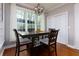 Charming dining room with wood floors and a lovely view of the trees outside the window at 4270 Parnell Rd, Marietta, GA 30062