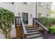 Inviting covered front porch with steps leading to front door and manicured shrubs at 4270 Parnell Rd, Marietta, GA 30062