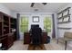 Well-lit home office space with built in bookcase, neutral colors, and dual windows at 4270 Parnell Rd, Marietta, GA 30062