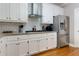 Bright kitchen featuring white cabinets, subway tile backsplash, stainless steel appliances, and wood flooring at 4270 Parnell Rd, Marietta, GA 30062