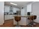 Modern kitchen features white cabinets, stainless steel appliances, and a granite countertop island with seating at 4270 Parnell Rd, Marietta, GA 30062