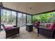 Covered brick patio with comfortable seating, ideal for outdoor relaxation and entertaining guests in a wooded backyard setting at 4270 Parnell Rd, Marietta, GA 30062