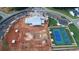 An aerial shot reveals community amenities, including tennis courts, and a clubhouse undergoing construction at 559 Southland Cir, Canton, GA 30115