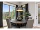 Cozy dining nook illuminated by natural light, featuring a modern pendant light and elegant furnishings at 559 Southland Cir, Canton, GA 30115