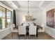 Bright dining room showcasing modern chandelier, light-colored walls, and large window at 559 Southland Cir, Canton, GA 30115