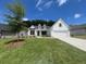 Charming, newly built single-story home with white painted brick, large front yard, and attached two-car garage at 559 Southland Cir, Canton, GA 30115