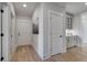 Hallway with hardwood floors, white trim, and doors to various rooms in the house at 559 Southland Cir, Canton, GA 30115