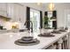 Close-up of a kitchen island featuring counter seating and modern appliances at 559 Southland Cir, Canton, GA 30115