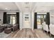 Inviting living room featuring wood floors, two windows, and an entrance with a glass door at 559 Southland Cir, Canton, GA 30115