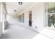Covered white patio with a back door, windows, and recessed lighting at 559 Southland Cir, Canton, GA 30115