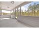 Covered white patio with screens offering views of the home's backyard landscape at 559 Southland Cir, Canton, GA 30115
