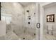 Modern bathroom featuring a glass-enclosed shower with white marble tile surround and a matte black shower head at 559 Southland Cir, Canton, GA 30115
