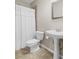 Clean bathroom featuring a shower with white curtain, pedestal sink, and neutral tiling at 611 Parkside Village Nw Way, Marietta, GA 30060
