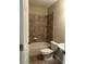 Well-lit bathroom with a shower-tub combo and a tiled wall creates a convenient space at 611 Parkside Village Nw Way, Marietta, GA 30060