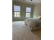 Spacious bedroom with neutral walls, two windows, and plush carpet create a relaxing retreat at 611 Parkside Village Nw Way, Marietta, GA 30060