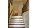 Entryway stairs featuring wood treads, white risers and decorative wrought iron railing at 611 Parkside Village Nw Way, Marietta, GA 30060