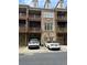 Attractive brick townhome with multiple balconies and attached garages for convenient parking at 611 Parkside Village Nw Way, Marietta, GA 30060
