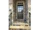 Charming front door with decorative glass, stone steps and brick surround at The Gates at Parkside Village at 611 Parkside Village Nw Way, Marietta, GA 30060