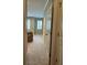 View down the hallway toward a bedroom with windows and neutral carpeting throughout at 611 Parkside Village Nw Way, Marietta, GA 30060