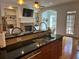 Modern kitchen with granite counters and stainless-steel appliances, opens into living space at 611 Parkside Village Nw Way, Marietta, GA 30060
