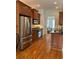 A kitchen featuring stainless steel appliances, wooden cabinetry, and hardwood floors at 611 Parkside Village Nw Way, Marietta, GA 30060