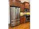 A kitchen with stainless steel refrigerator, wooden cabinets, and dark countertops at 611 Parkside Village Nw Way, Marietta, GA 30060
