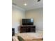 Comfortable living room featuring a large television on a wooden cabinet and neutral carpeting at 611 Parkside Village Nw Way, Marietta, GA 30060