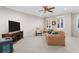 Spacious living room with neutral carpeting, a ceiling fan, and plentiful natural light from large windows at 611 Parkside Village Nw Way, Marietta, GA 30060