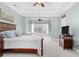 Bright bedroom with sitting area, tray ceilings, and access to ensuite bathroom at 611 Parkside Village Nw Way, Marietta, GA 30060