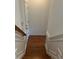 Wooden staircase with white banisters leading down to the lower level of the home at 611 Parkside Village Nw Way, Marietta, GA 30060
