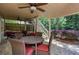 Relaxing covered back patio with ceiling fan, dining table and lounge seating at 131 Helmswood Sw Cir, Marietta, GA 30064