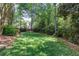 Lush green backyard featuring mature trees and landscaping at 131 Helmswood Sw Cir, Marietta, GA 30064