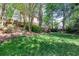 Spacious backyard featuring lush green grass, landscaping, and a charming playhouse at 131 Helmswood Sw Cir, Marietta, GA 30064