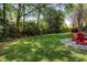 Spacious backyard with mature trees and a paved patio area with outdoor furniture at 131 Helmswood Sw Cir, Marietta, GA 30064