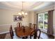 Bright dining room features a classic chandelier, large windows, and a traditional dining set at 131 Helmswood Sw Cir, Marietta, GA 30064