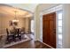 Elegant entryway leads to a dining room, showcasing wood floors, coffered ceiling, and natural light at 131 Helmswood Sw Cir, Marietta, GA 30064