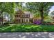 Beautiful brick home featuring a manicured lawn and lush landscaping at 131 Helmswood Sw Cir, Marietta, GA 30064