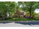 Well-maintained brick home with a professionally landscaped front yard and mature trees at 131 Helmswood Sw Cir, Marietta, GA 30064