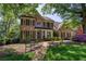 Charming brick home with manicured landscaping, a welcoming front porch and a bench at 131 Helmswood Sw Cir, Marietta, GA 30064