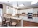 Modern kitchen with granite countertops, white cabinetry, stainless steel appliances, and a breakfast bar at 131 Helmswood Sw Cir, Marietta, GA 30064