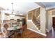 Open concept kitchen and staircase with white cabinets, stainless steel appliances, and wood flooring at 131 Helmswood Sw Cir, Marietta, GA 30064