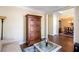 Comfortable living room with armoire and a view into the dining room, designed with neutral tones at 131 Helmswood Sw Cir, Marietta, GA 30064