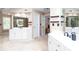 Open bathroom concept featuring dual vanities, a jacuzzi tub, and two separate entrance doorways at 131 Helmswood Sw Cir, Marietta, GA 30064