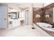 Elegant bathroom features dual sinks with white vanities, jacuzzi tub with marble accents, and lots of natural light at 131 Helmswood Sw Cir, Marietta, GA 30064