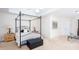 Comfortable main bedroom featuring a black four poster bed, bedside tables, and a leather storage ottoman at 131 Helmswood Sw Cir, Marietta, GA 30064