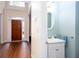 Charming powder room with pedestal sink, complemented by a light color palette and a transom window at 131 Helmswood Sw Cir, Marietta, GA 30064