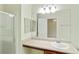 Bright bathroom featuring a vanity, sink, large mirror, and a glass-enclosed shower stall at 168 Ellis Dr, Conyers, GA 30012